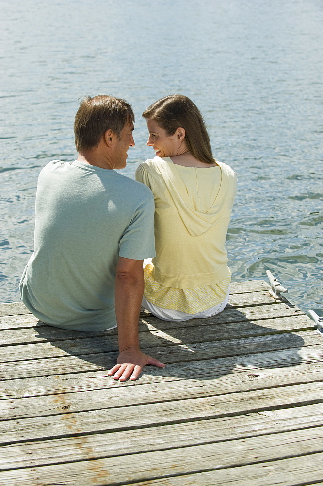 Couple sitting on dock