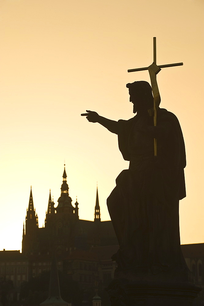 Silhouetted statue and cathedral