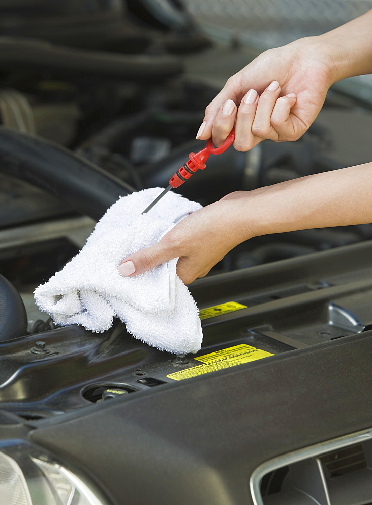 Mechanic checking oil