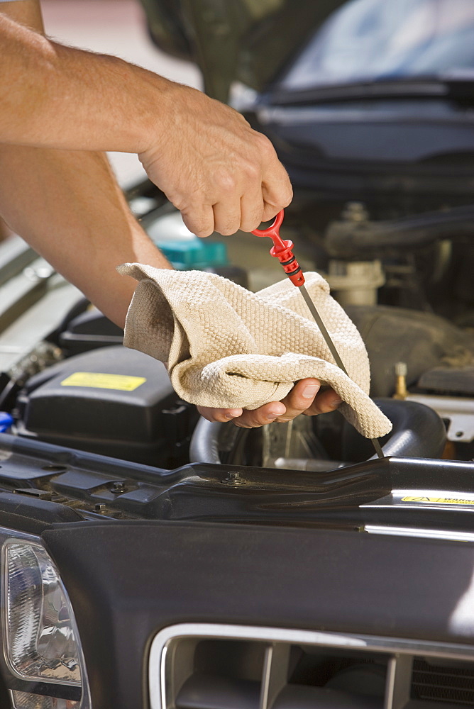 Mechanic checking oil