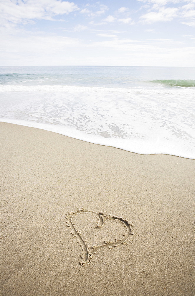 USA, Massachusetts, Hearts drawn on sandy beach