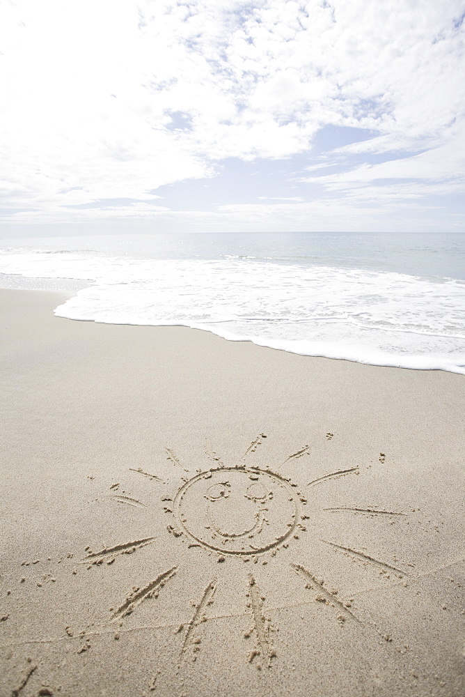 USA, Massachusetts, Sun drawn on sandy beach