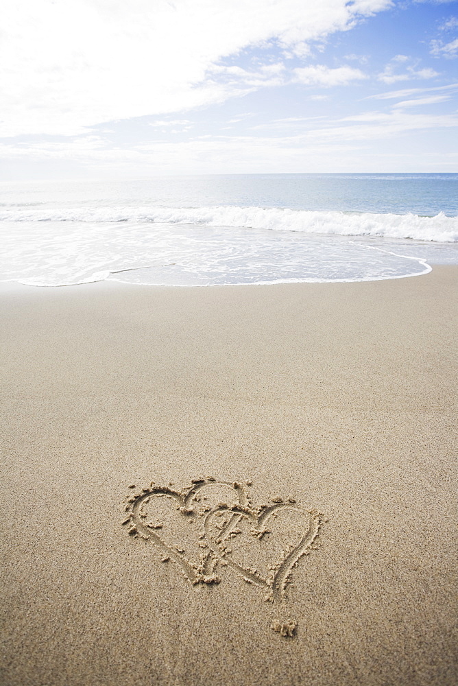 USA, Massachusetts, Hearts drawn on sandy beach