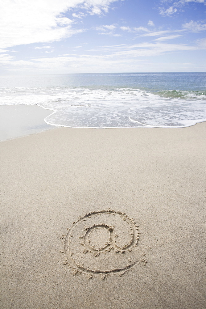 USA, Massachusetts, At sign drawn on sandy beach