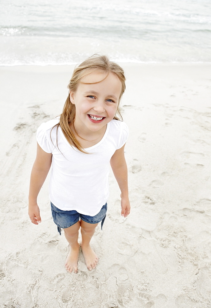 Portrait of smiling girl (10-11) at beach