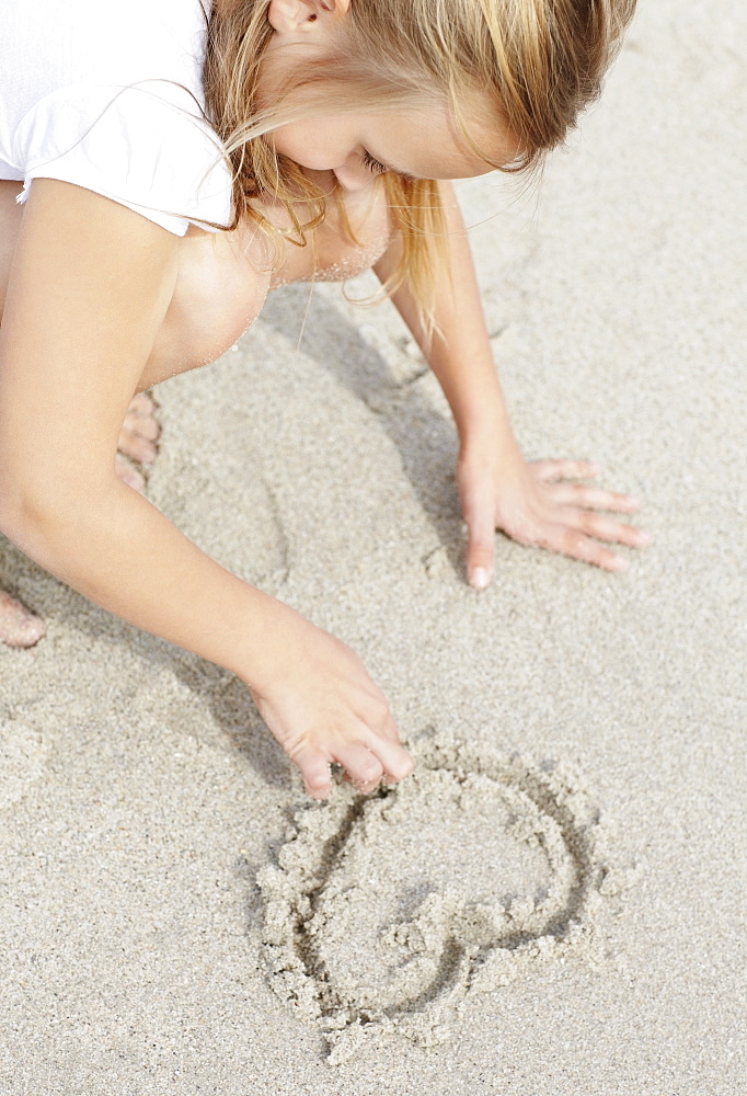 Girl (10-11) playing on beach