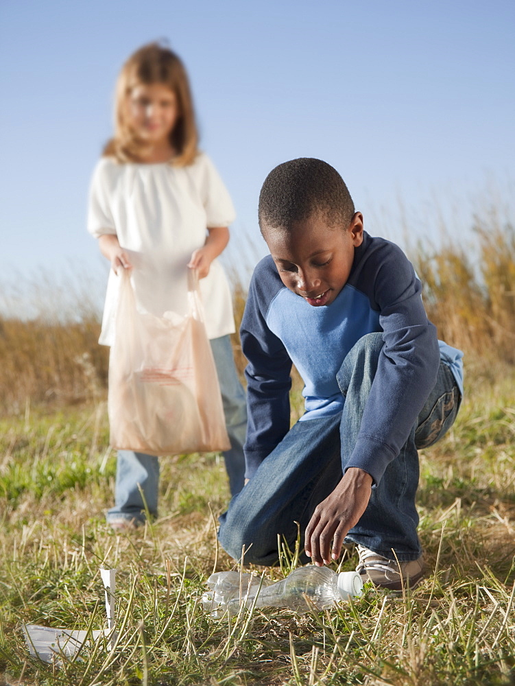 Young children picking up litter