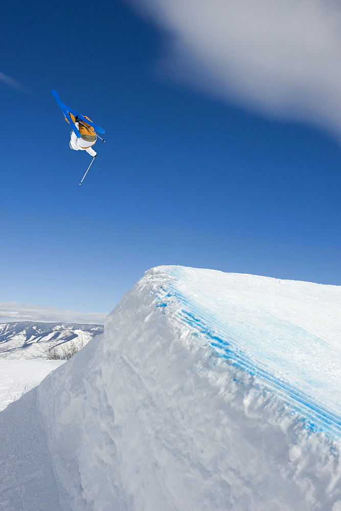 A downhill skier jumping