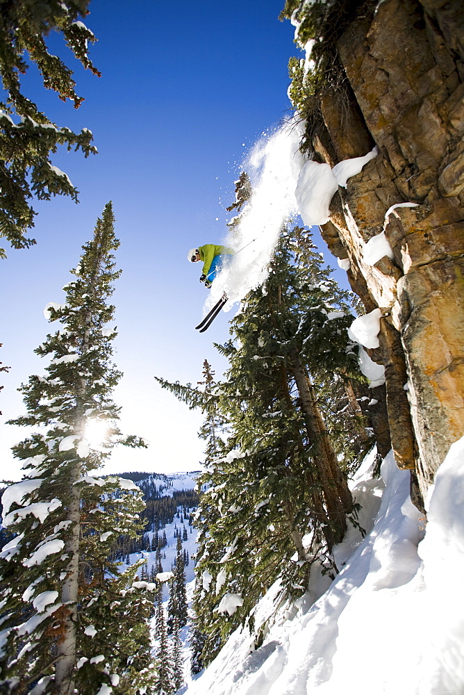 Skier jumping off cliff Aspen Snowmass, Aspen, Colorado, USA 