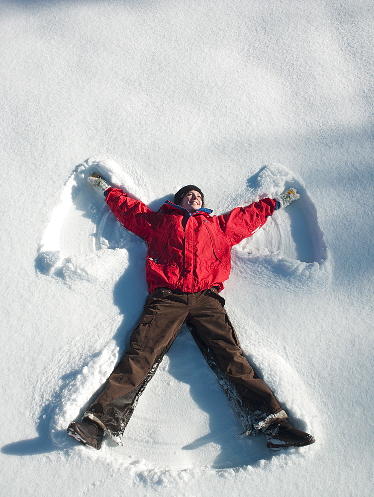 Woman making snow angel