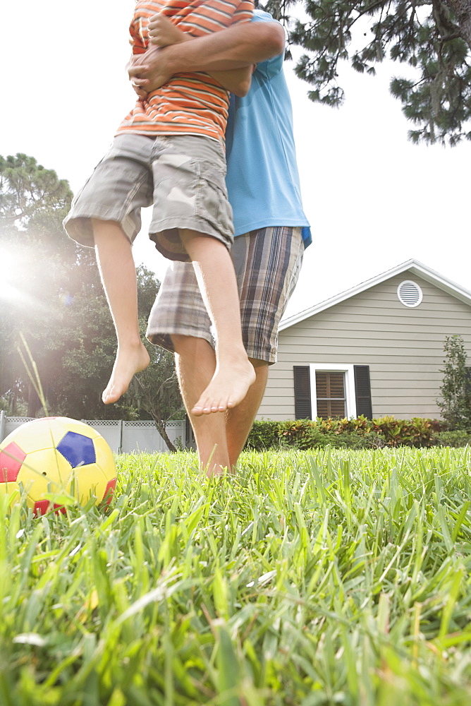 Father and son playing in backyard