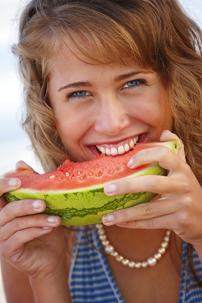 Young woman eating watermelon