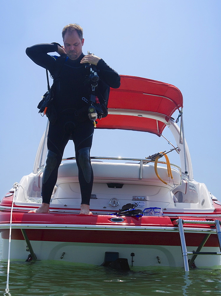 Man with scuba gear on boat, Florida, United States