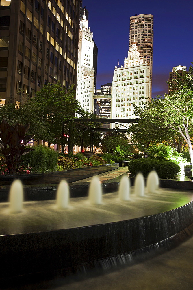 USA, Illinois, Chicago, Fountain and Wrigley Building illuminated at night