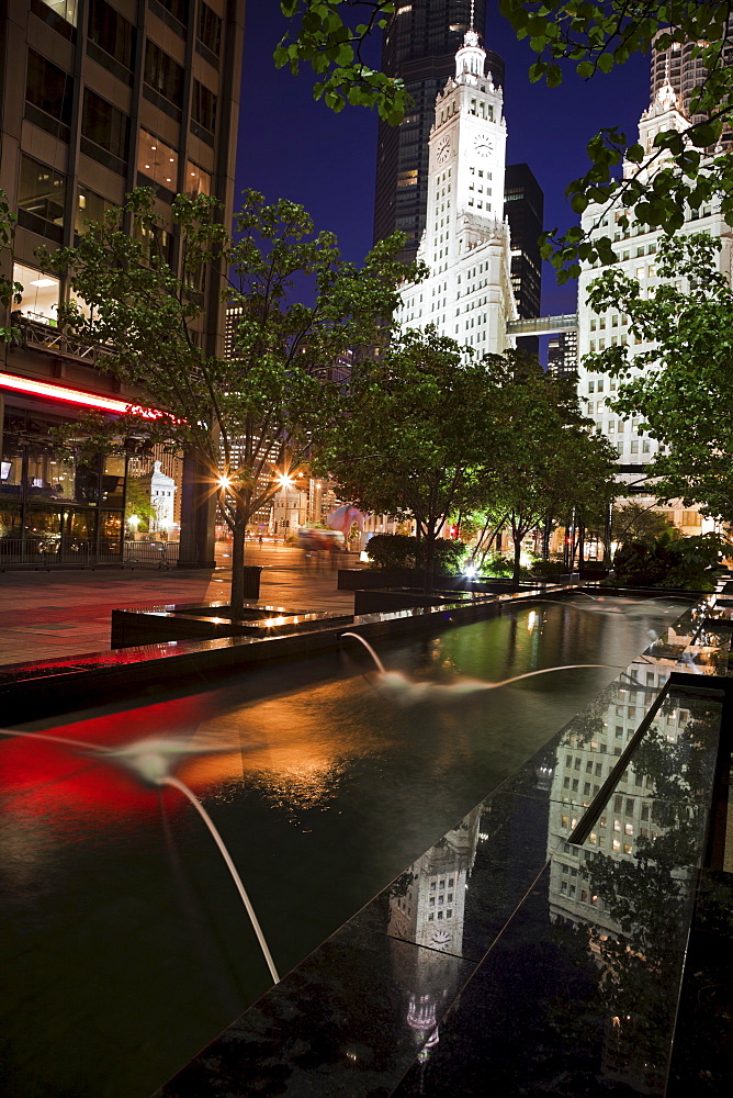 USA, Illinois, Chicago, Fountain and Wrigley Building illuminated at night