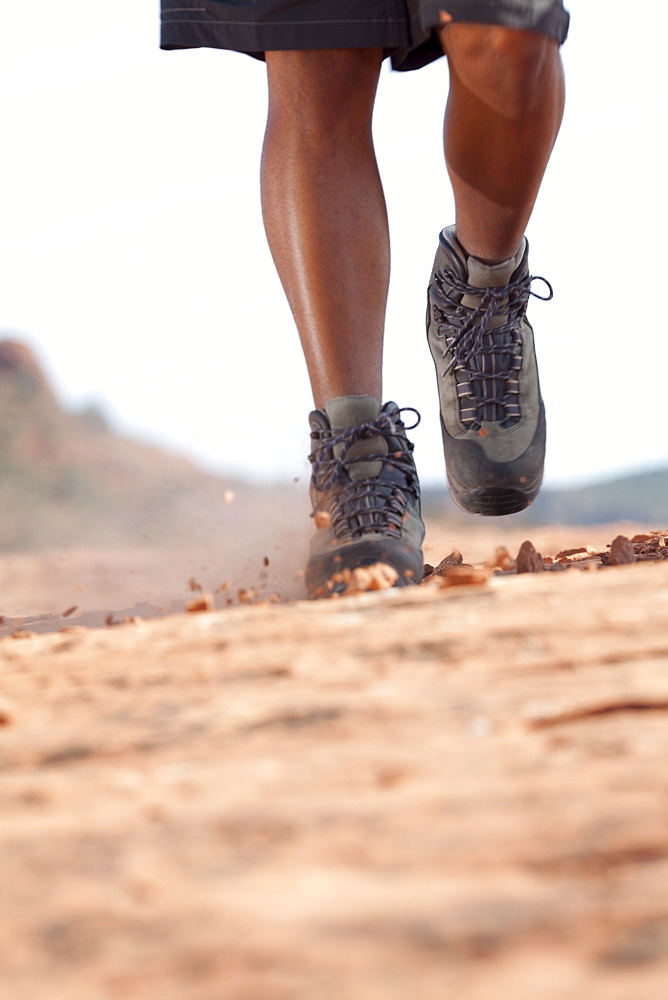 Hiking boots moving across rocky surface