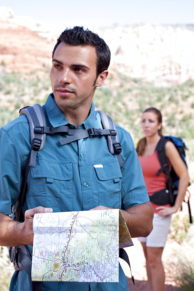USA, Arizona, Sedona, Young couple hiking, man holding map