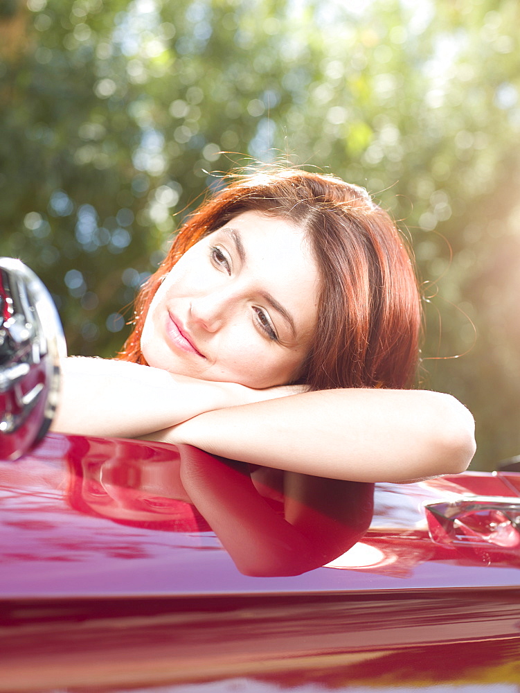 Smiling young woman in convertible car