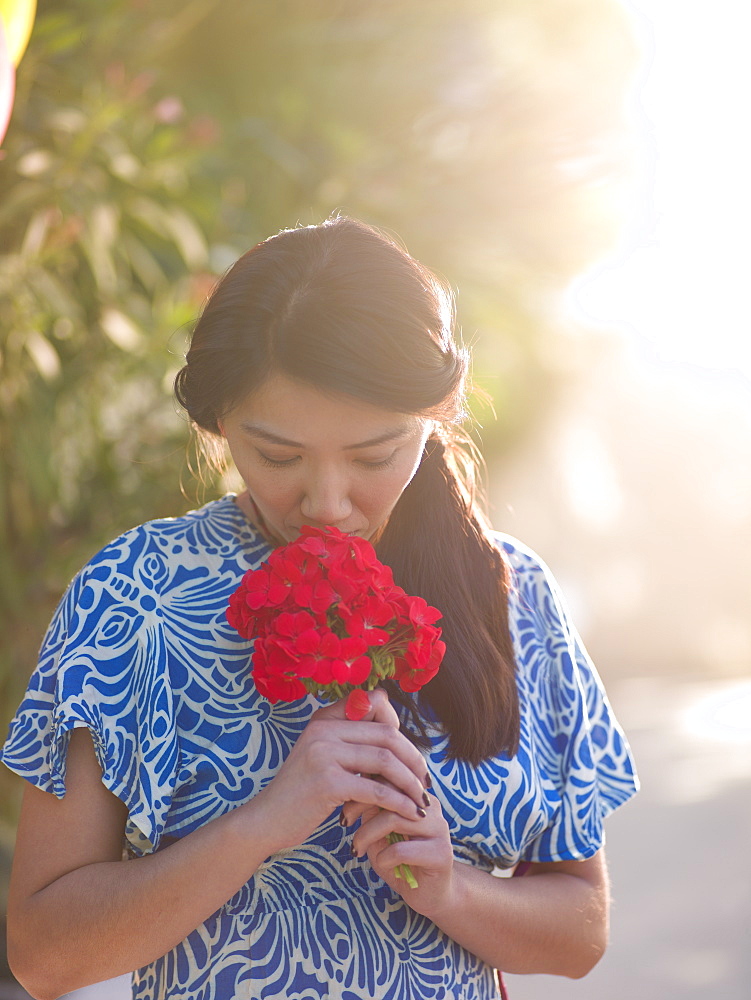 Mid adult woman smelling bouquet