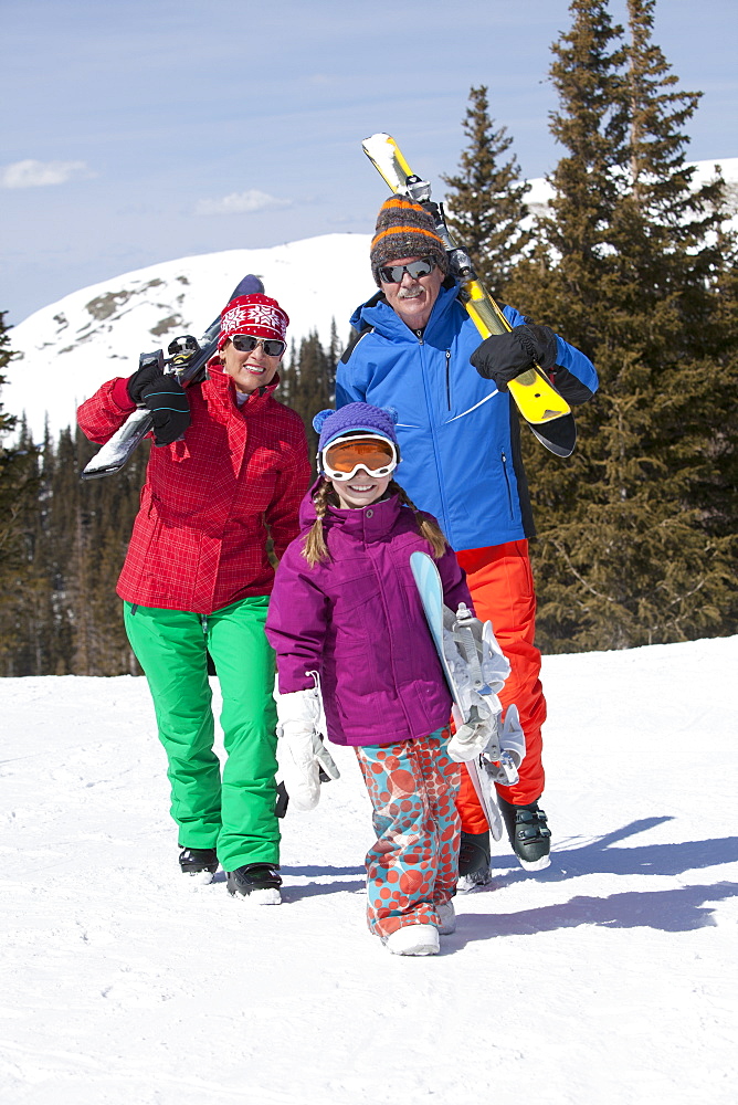 USA, Colorado, Telluride, Grandparents with girl (10-11) posing during ski holiday