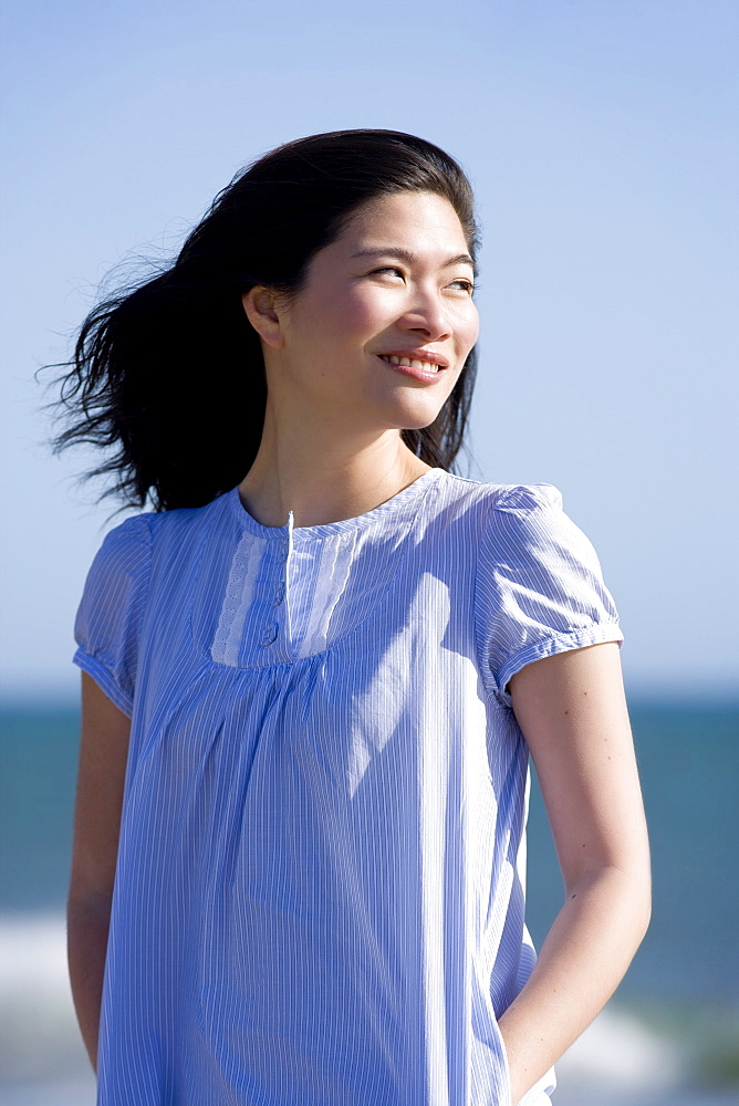 USA, California, Point Reyes, Pensive young woman at coast