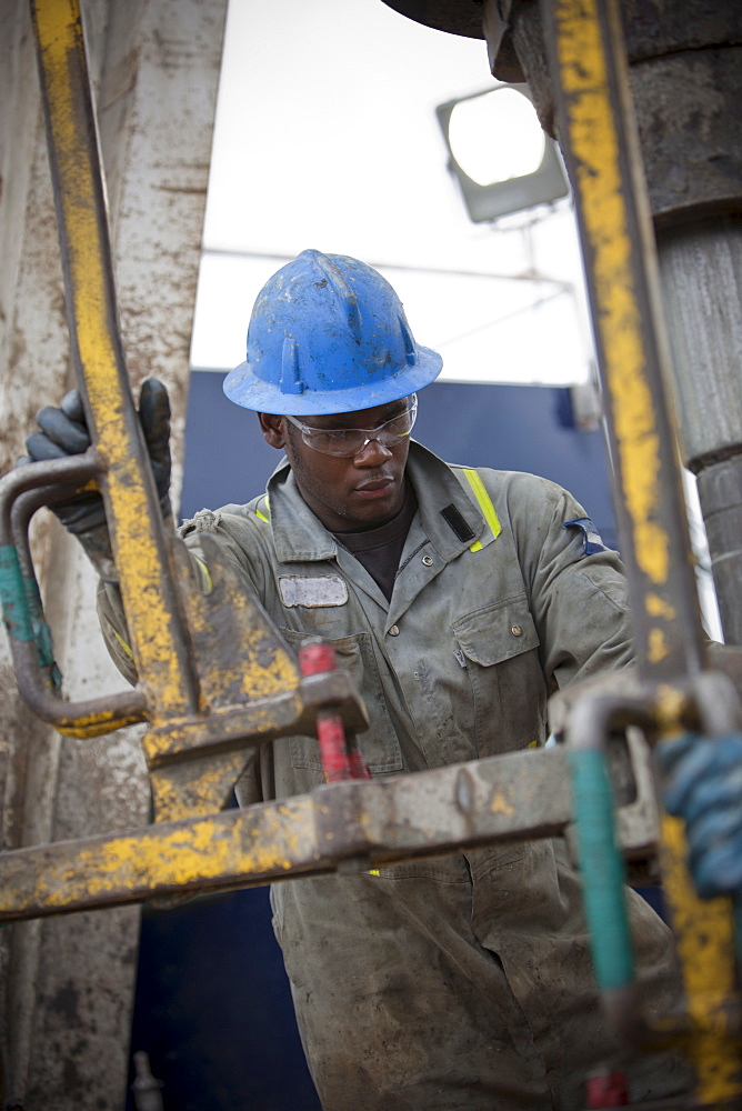 Oil worker drilling for oil on rig