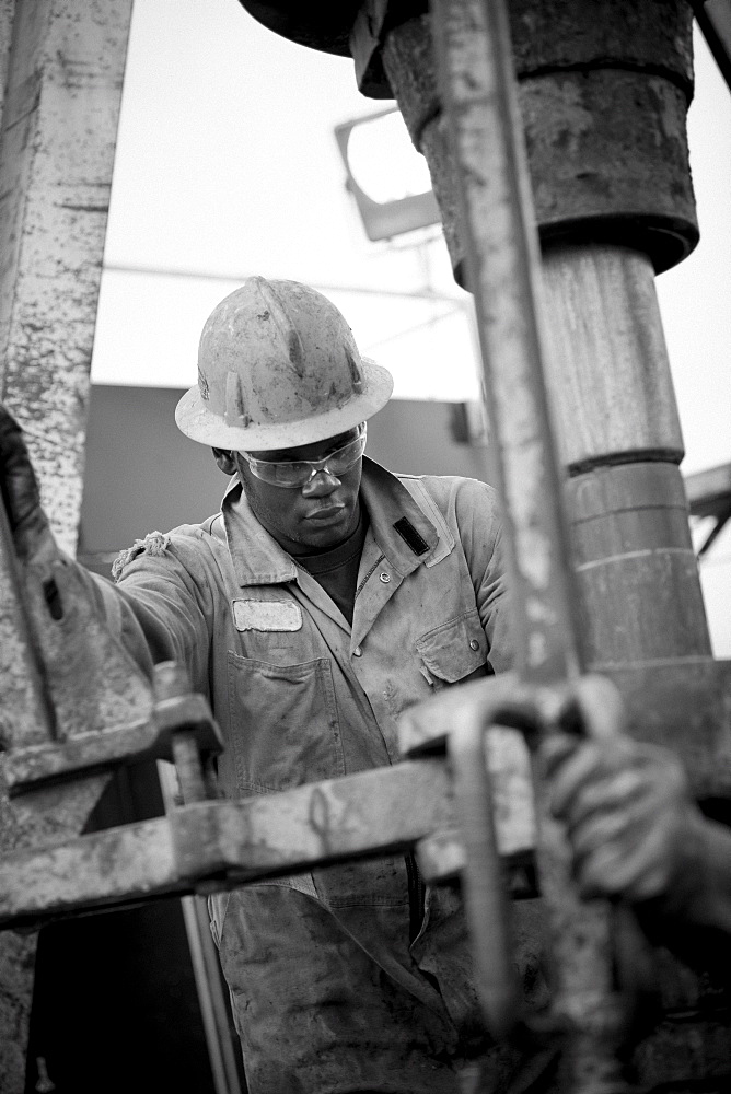 Oil worker drilling for oil on rig