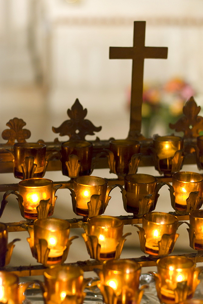 Cross with candles in cathedral