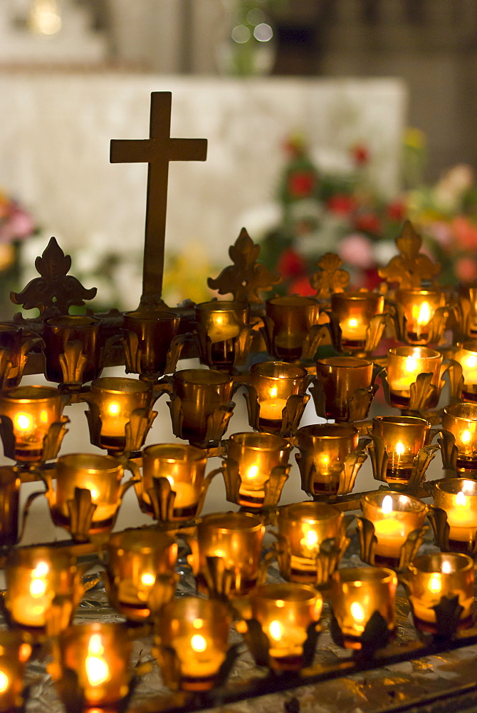 Cross with candles in cathedral