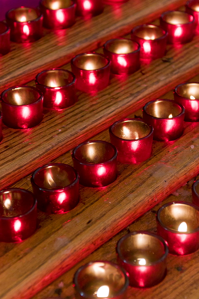 Rows of candles in cathedral