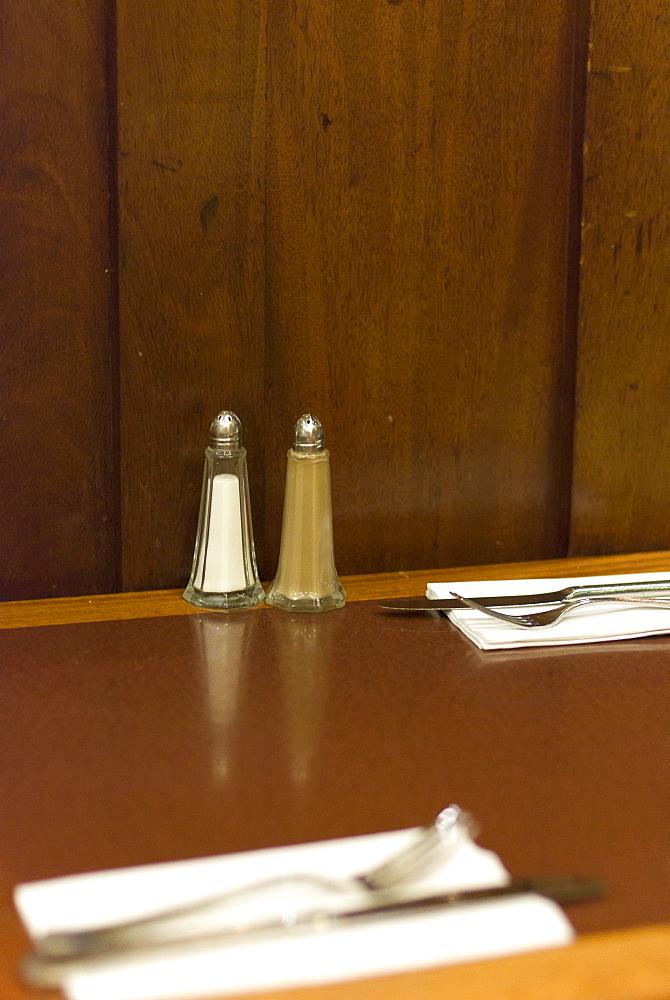 Salt and pepper condiments on cafe table