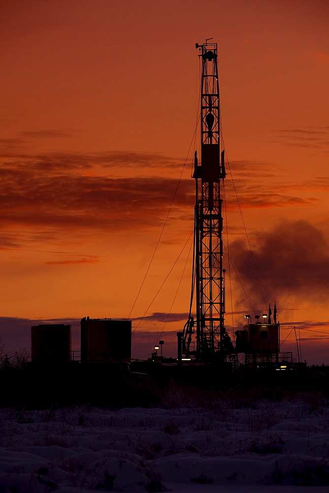 Oil drilling rig at dusk