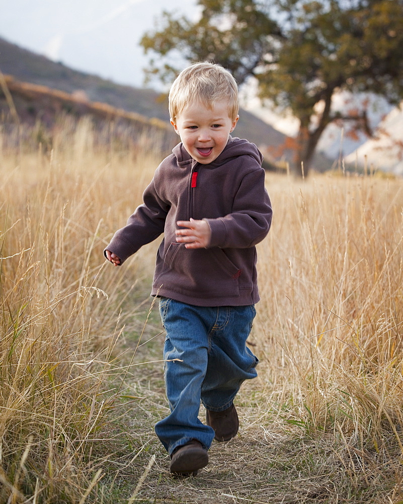 Boy running in meadow