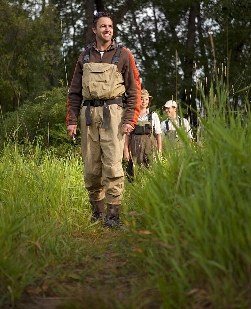 Fly Fisherman walking on path