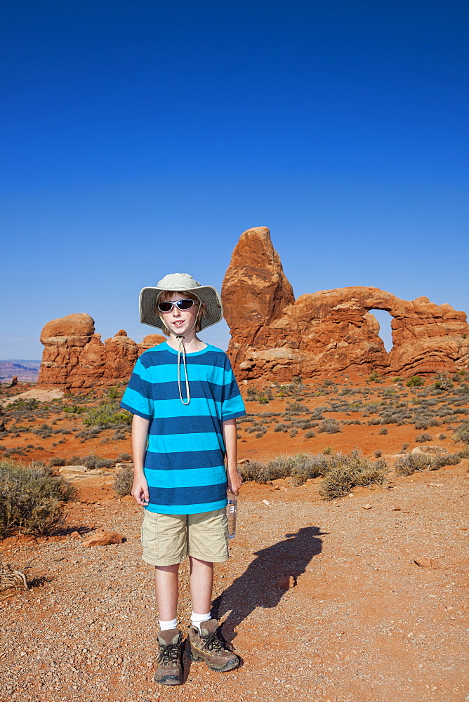 Young Boy in front of Turret Arch, Arches National Park, Utah