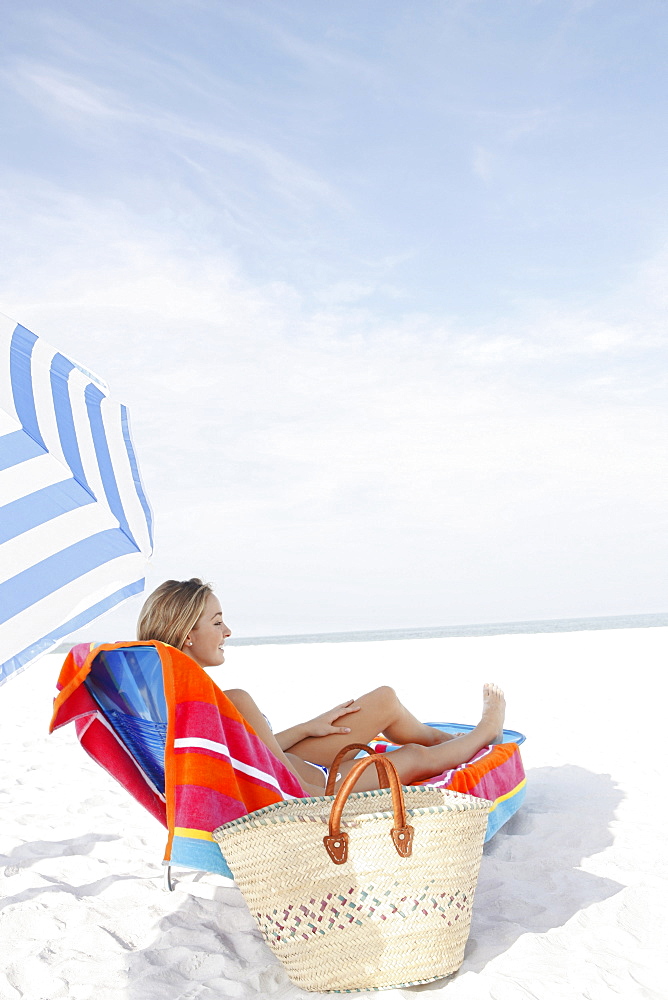 Teenage girl sunbathing on beach