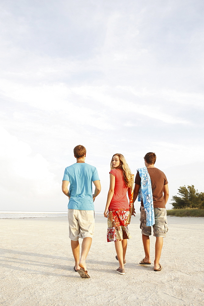 Friends walking on beach