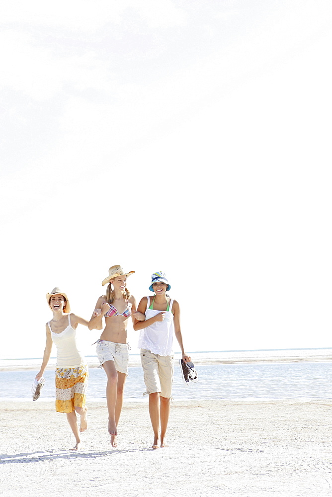 Young women walking on beach