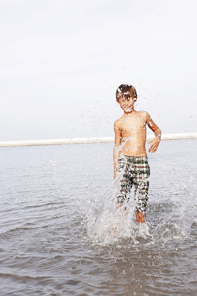 Boy splashing in ocean