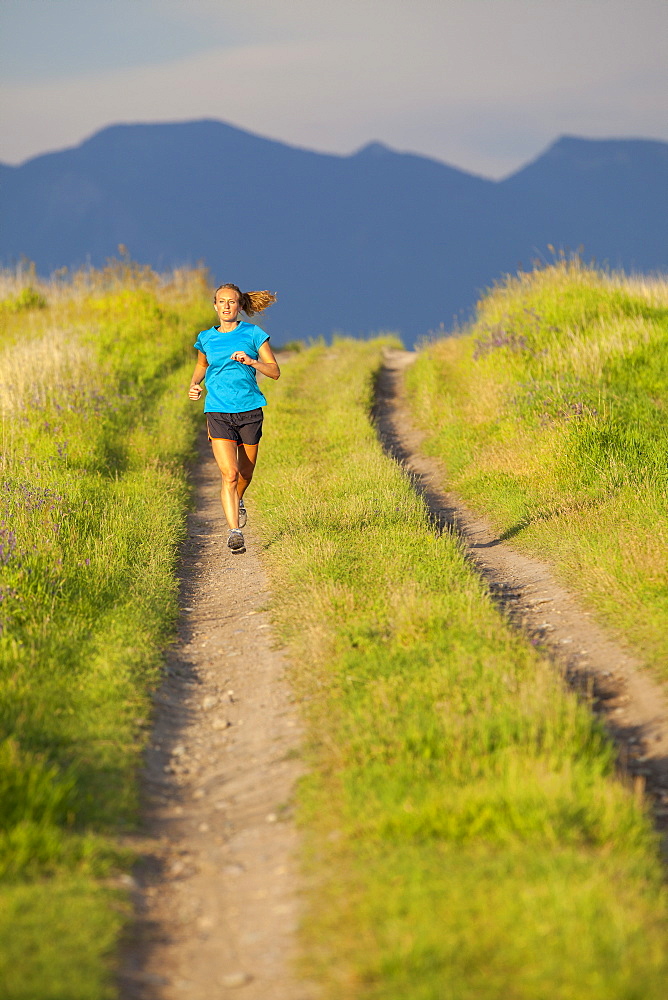 Front view of young woman jogging, Kalispell, Montana, USA