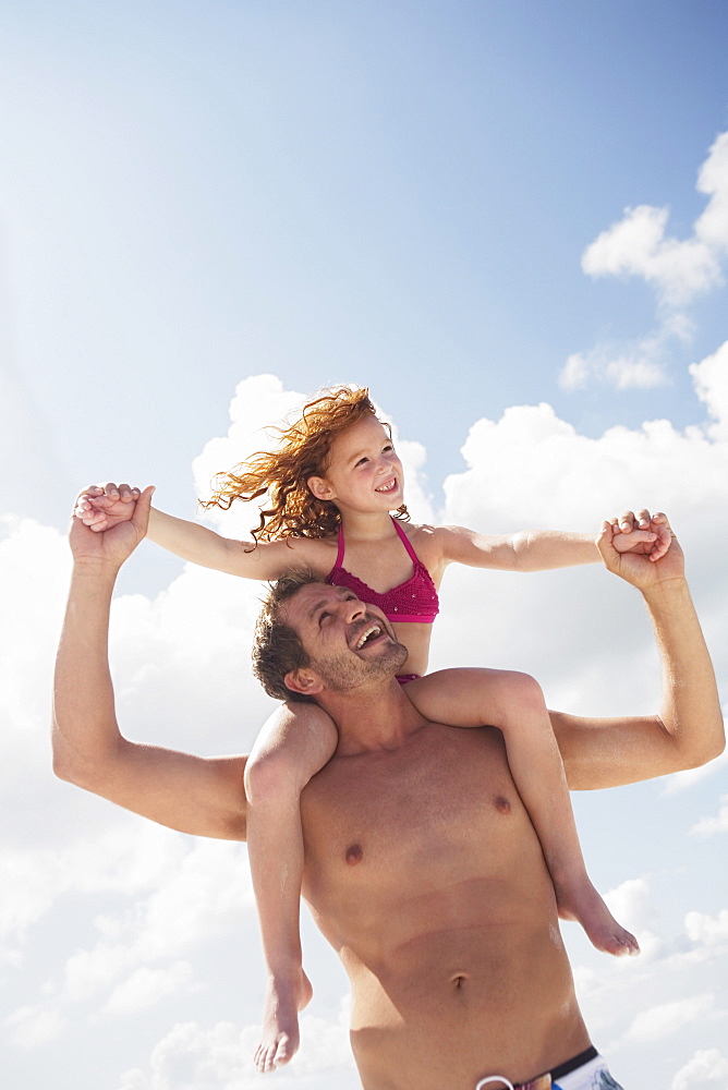 Father carrying daughter in shoulders