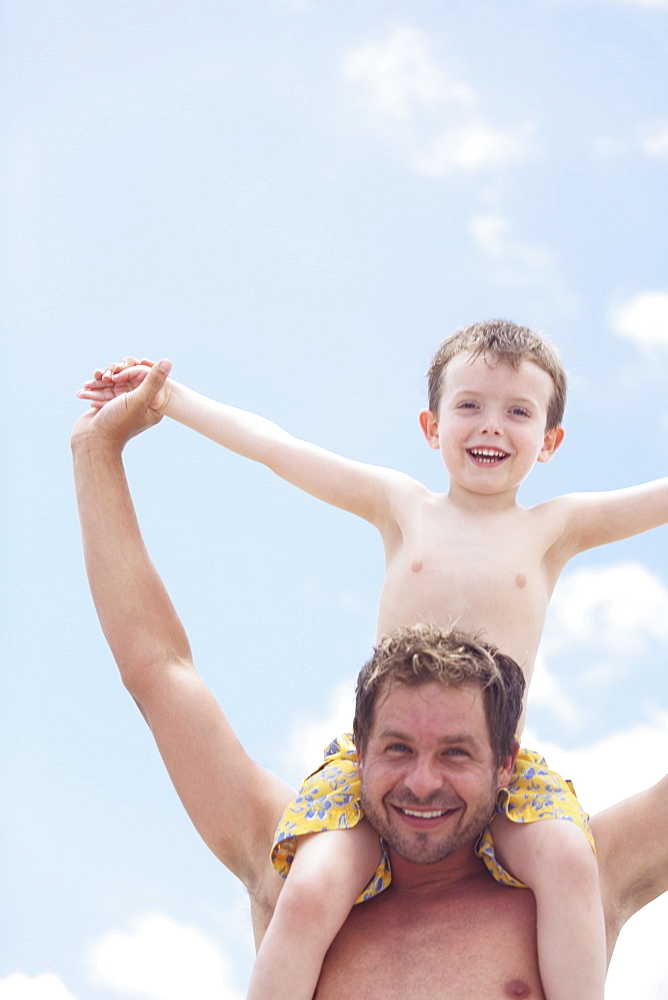 Father carrying son on shoulders