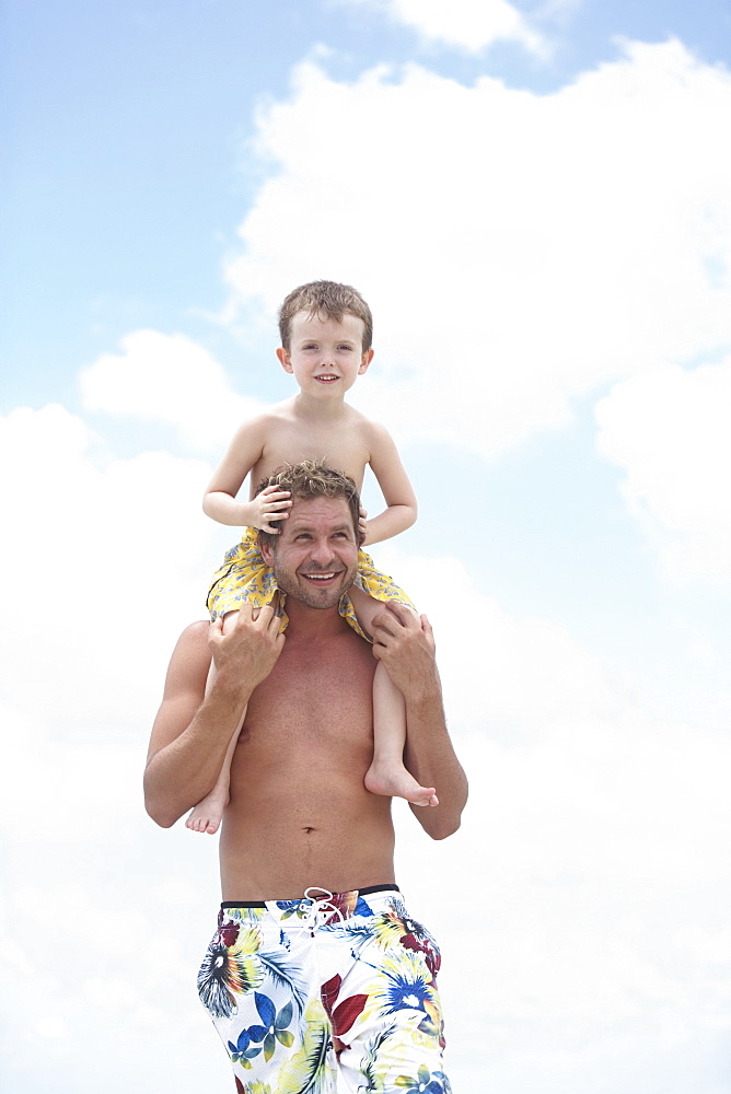 Father carrying son on shoulders