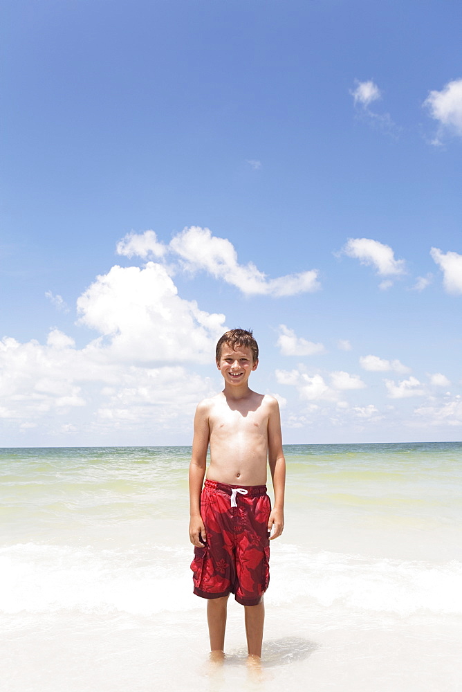 Boy standing in ocean