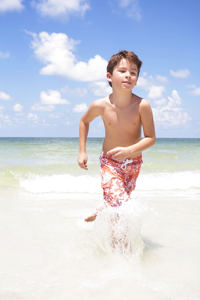 Boy running in ocean