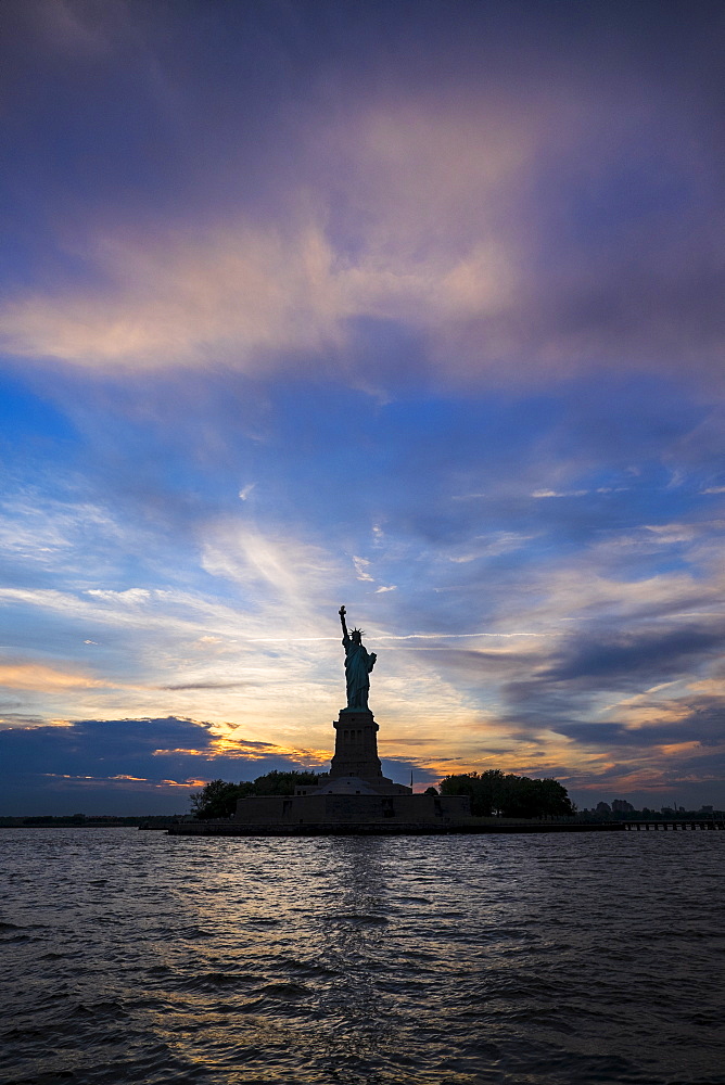 Silhouette of Statue of Liberty at sunset, New York City, New York