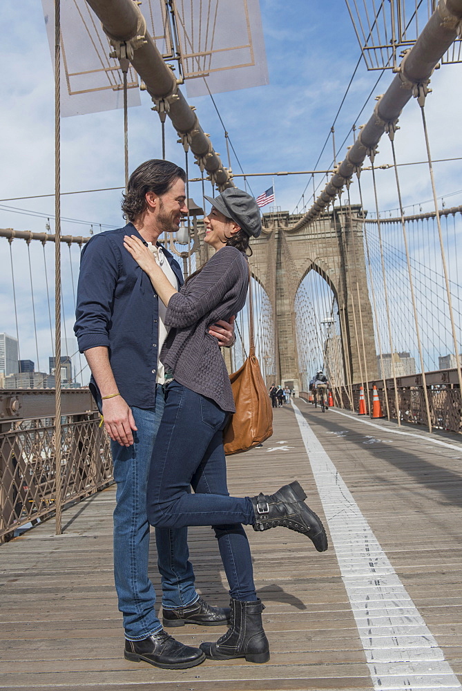 Happy couple embracing on Brooklyn Bridge, Brooklyn, New York