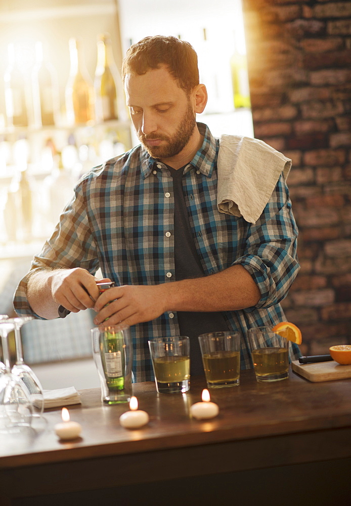 Bartender opening bottle