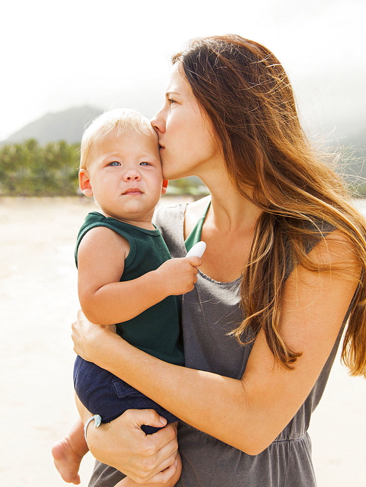 Young mother with baby daughter (6-11 months), Kauai, Hawaii