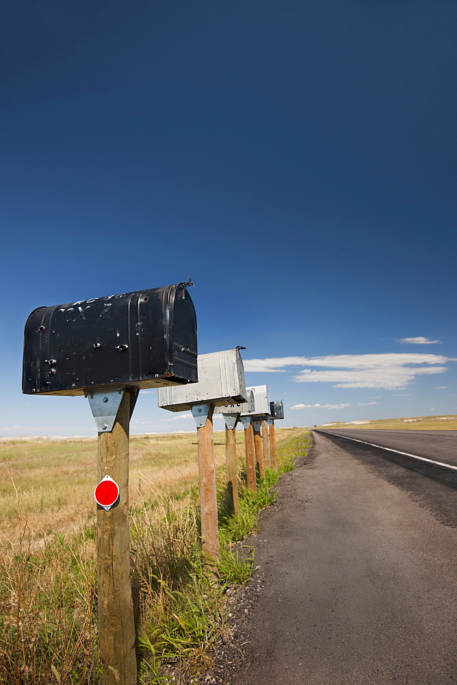 USA, South Dakota, Row of rural mailboxes on roadside